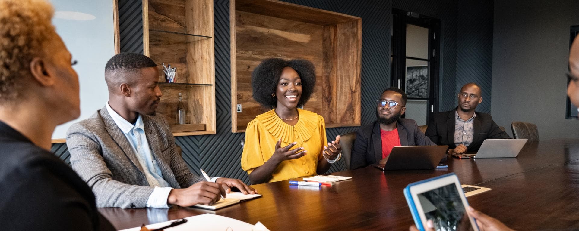 A team collaborating around laptops in an office