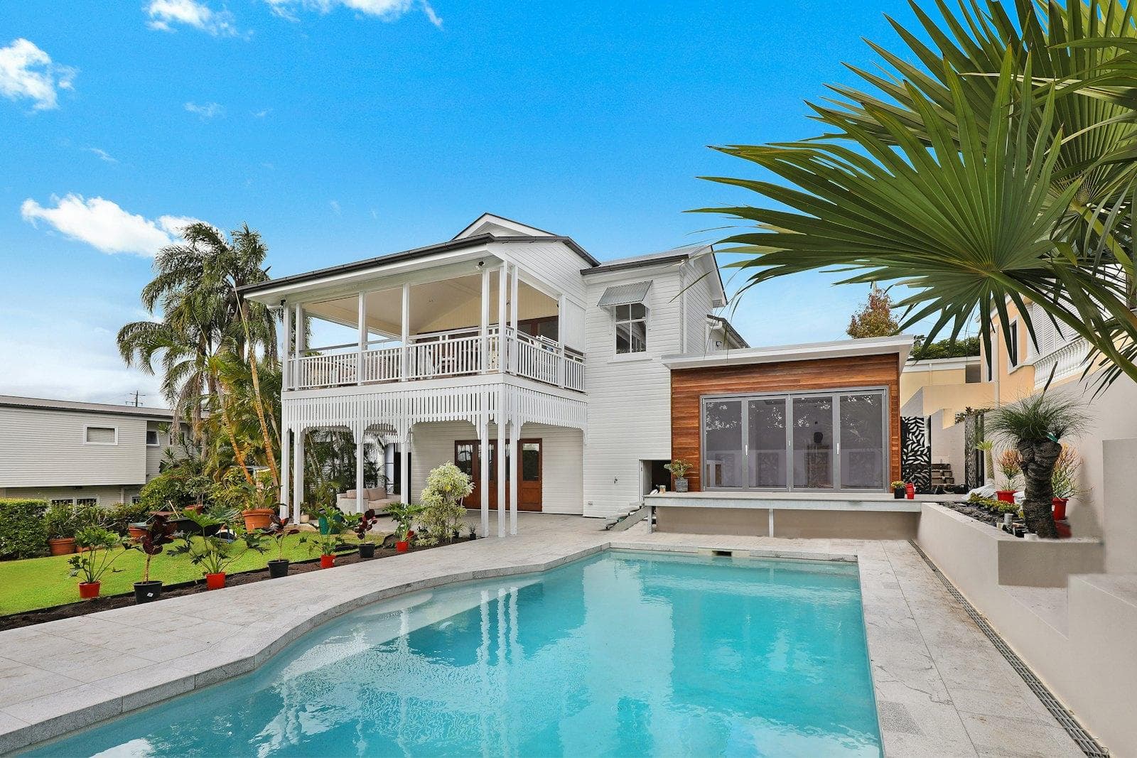 A furnished living room opening onto a pool